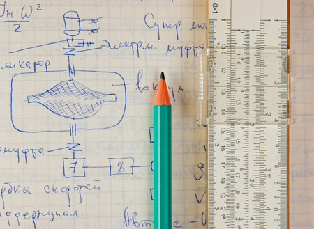pencil and a slide rule on the old page with the calculations in mechanicsの写真素材