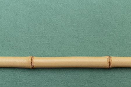 bamboo stick on a green wallの写真素材