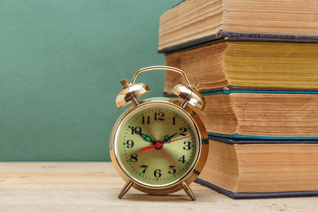 old books and alarm clockの写真素材