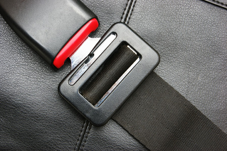 seat belt on a black leather chairの写真素材