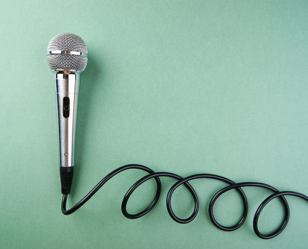 Classic dynamic microphone on a green backgroundの写真素材