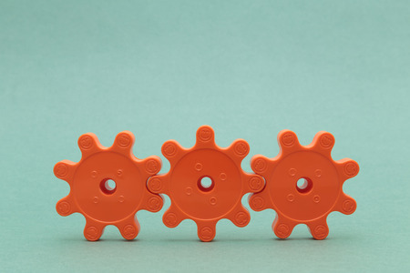 three red plastic gearsの写真素材