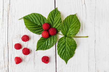 Raspberries on a wooden white table
