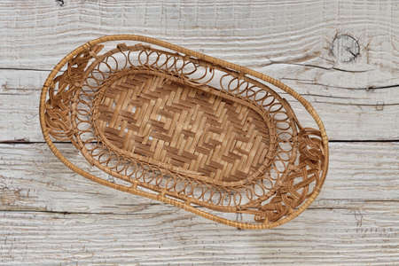 Empty basket on an old wooden tableの写真素材