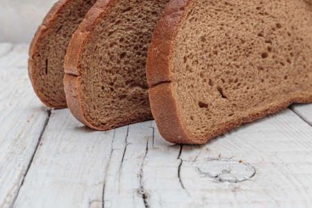 slices of rye bread on a wooden tableの写真素材