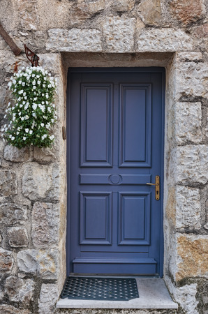 Old wooden door in the entrance stone French houseの写真素材