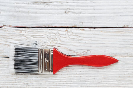 Paint brush on a white wooden boardの写真素材