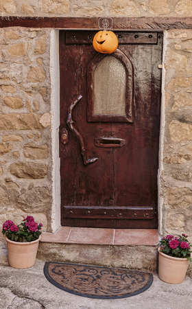 Old wooden door in the entrance stone French houseのeditorial素材