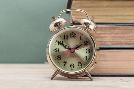 old books and alarm clockの写真素材