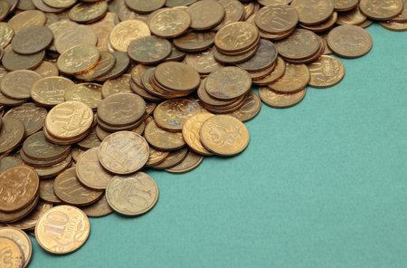 heap of coins on a green backgroundの写真素材