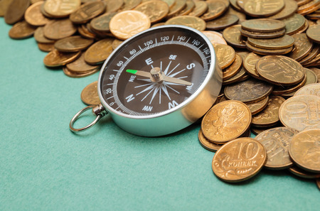 compass on a heap of coinsの写真素材