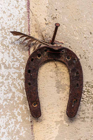 old rusty horseshoe on a stone wallの写真素材