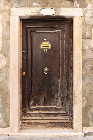Old wooden door in a stone house Italianのeditorial素材