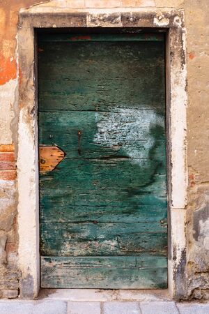 Old wooden door in a stone house Italianのeditorial素材