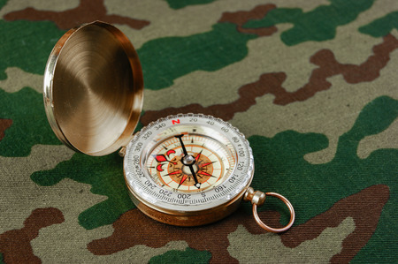 Compass on a camouflage backgroundの写真素材