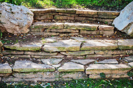 Old stone steps overgrown with grassの写真素材