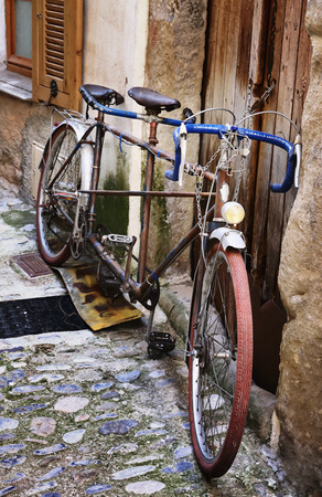 Old bicycle on a medieval street in Franceの写真素材
