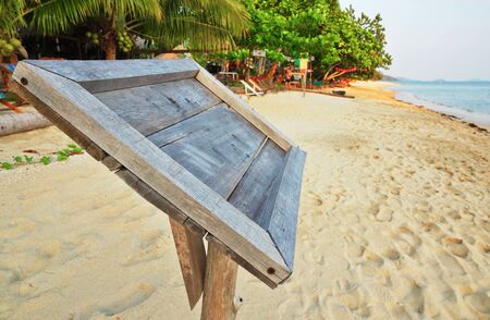 Empty old wooden Whiteboard (menu board) on a tropical beachの写真素材