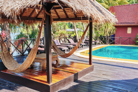 Hammock under sunshade in a tropical garden near the poolのeditorial素材