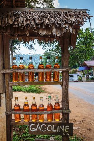 Bottles with gasoline on a rural roadside gas station in Thailandの写真素材
