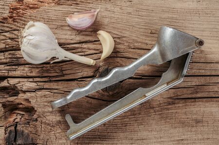 Straw chopper garlic on old wooden boardsの写真素材