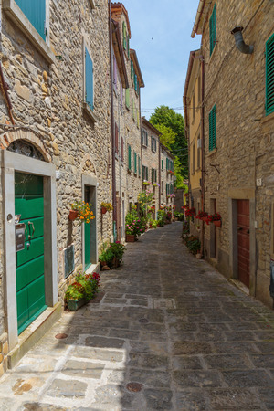 Narrow old street with flowers in Italyの写真素材