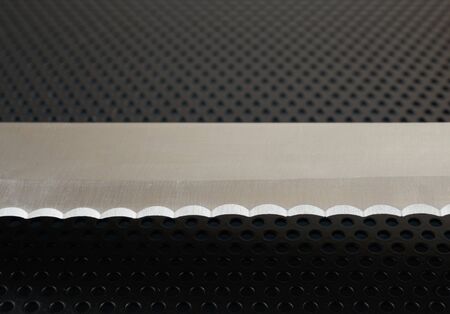 Close up of the blade of stainless steel bread knife