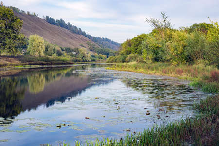 Pond in the countryside in autumn at sunset