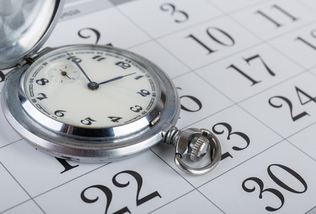 Old pocket watch on the calendarの写真素材