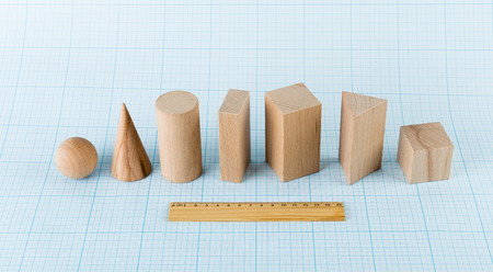 Wooden geometric shapes on graph paperの写真素材