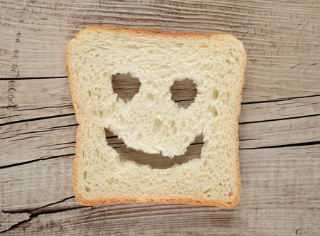 Happy toast on an old wooden boardの写真素材