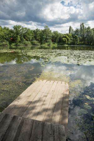 Old wooden gangway on the lakeの写真素材