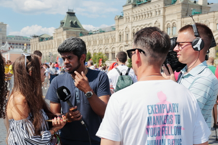 MOSCOW, RUSSIA - June 27, 2018: TV reporters are interviewing Football fans on the Red Square in Moscow during the World Cupのeditorial素材