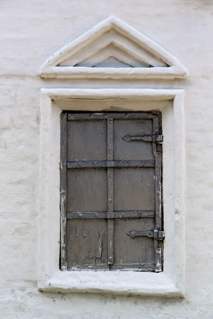Old window in the stone wall of the monasteryの写真素材
