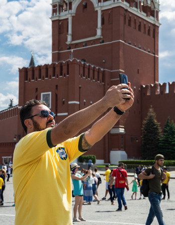MOSCOW, RUSSIA - June 27, 2018: A man tourist  makes a selfie on Red Squareのeditorial素材