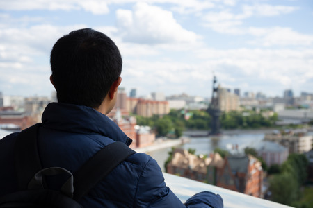 The tourist looks at the city of Moscow from the top viewpointの写真素材