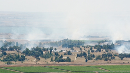 JUNE 06: Artillery fire in Syrian city Al Qunaytirah on Golan Heights on June 06, 2013 in Syriaのeditorial素材