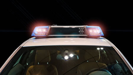 Flash lights and siren on the police car against blackの写真素材