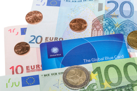 MUNICH, GERMANY - FEBRUARY 23, 2014: Global Blue Tax Free card against Euro notes and Cent coins. Isolate on white.のeditorial素材