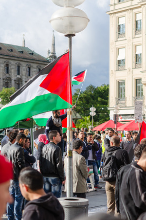 MUNICH, GERMANY - AUGUST 16, 2014: Palestinian flags, slogans and posters. Demonstration for peace, freedom and independence, and ending the war in Gaza.のeditorial素材