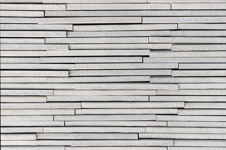Light grey or white stone plates layers rough textured backgroundの写真素材