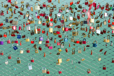 A many of locks on the bridge which the friends or lovers hanging as a symbol of loyalty and eternal...
