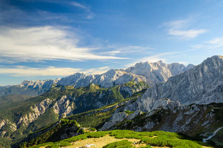 Aerial landscape view of summer Alps sunlight high mountain peaks with green valley and deep blue skyの写真素材