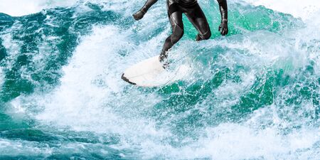 Surfing on turquoise ocean wave with close-up water splashesの写真素材