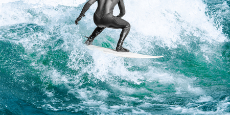 Close up surfer rides high speed on turquoise blue ocean big wave with water splashes