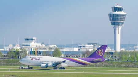 Munich, Germany - May 6, 2016: Jet airliner Boeing 747-400 of Thai Airways International airlines taxiing on pushback tug at Munich international passenger airportのeditorial素材
