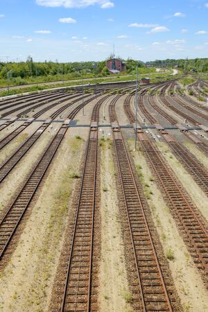 Empty freight railway classification yard with many tracks and operations control tower in the north of Munich. Vertical stock photo.の写真素材