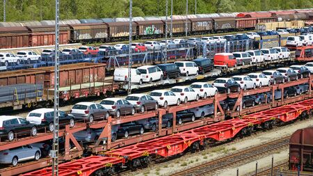 Munich, Germany - July 10, 2019: lots of new cars loaded on railway autorack wagons and ready for shipment from factories to automotive distributorsのeditorial素材