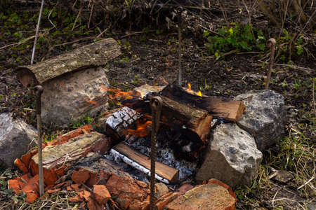 Rest in the garden in nature, preparing a fire for making a barbecue, fire from cherry wood