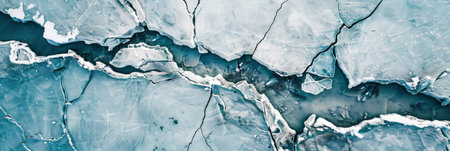The frozen river's cracked ice patterns are mesmerizing from the air, photography emphasizes the cool blues and whites, bannerの素材